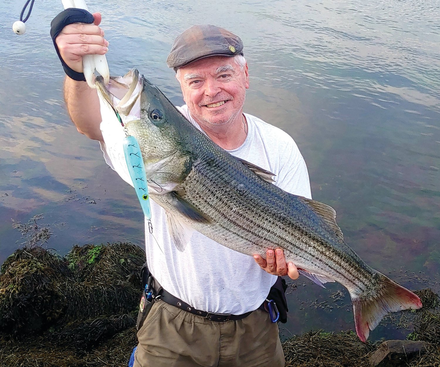 STRIPED BASS: East End Eddie Doherty with the 21-pound striped bass he caught last week on the Cape Cod Canal. 